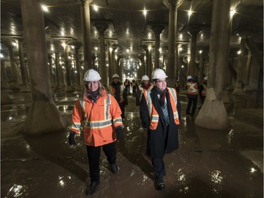 Denis Coderre, right, walks through the interior of the empty Rosemont water reservoir during a site tour in Montreal on Thursday, January 23, 2014. The reservoir, which was built in the 1960s and put out of service in the 1978, holds approximately 227,000 cubic metres of water and will be renovated and put back into service to increase the city's water reserves by 40 per cent at a cost of $73 million.