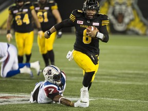 Tiger-Cats quarterback Jeremiah Masoli scrambles to avoid Alouettes defensive-end John Bowman during first half Friday night in Hamilton.