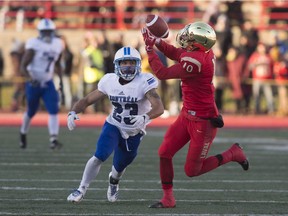 Laval University Rouge et Or receiver Marc-Antoine Pivin, right, catches a long pass ahead of Jordan Perrin of the Montréal Carabins during second-quarter action of the Dunsmore Cup Saturday, Nov. 11, 2017 in Quebec City.