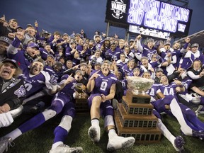 The Western Mustangs pose for a team photo with the Vanier Cup after defeating the Laval Rouge et Or in Hamilton, Ont., on Saturday, November 25, 2017.