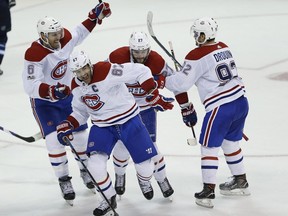 Canadiens' Shea Weber (6), Max Pacioretty (67), Alex Galchenyuk (27) and Jonathan Drouin (92) celebrate Pacioretty's game-winning goal against the Winnipeg Jets in overtime in Winnipeg on Saturday, Nov. 4, 2017.