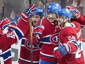 Canadiens' Max Pacioretty (67) celebrates with teammates Victor Mete (53) and Phillip Danault after scoring during overtime against the Buffalo Sabres, in Montreal on Saturday, Nov. 11, 2017.