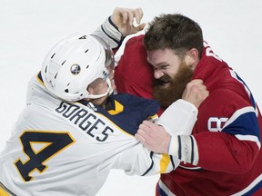 Montreal Canadiens' Jordie Benn and Buffalo Sabres' Josh Gorges fight during first period in Montreal, Saturday, Nov. 11, 2017.