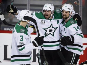 Dallas Stars right wing Alexander Radulov (47) celebrates his goal with defenceman John Klingberg (3) from Sweden, and left wing Jamie Benn (14) during third period NHL hockey action against the Calgary Flames in Calgary, Friday, Oct. 27, 2017.