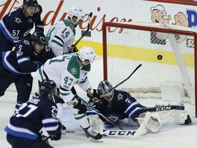 Alexander Radulov (47) of the Dallas Stars scores on Winnipeg Jets goaltender Connor Hellebuyck during first-period action in Winnipeg on Thursday, Nov. 2, 2017.