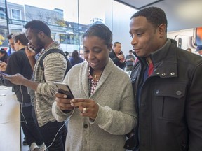Tanya Lacroix and Vladimir Ducas check out the new iPhone X at the Apple store Friday, November 3, 2017 in Montreal.