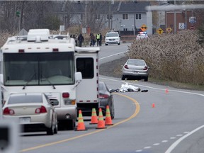 Laval police investigate the scene where a motorist drove over a body on the roadway in Laval on Wednesday November 8, 2017.