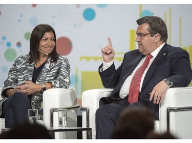 Paris Mayor Anne Hidalgo, left, looks on as Montreal Mayor Denis Coderre makes a point during their discussion at the XII Metropolis World Congress Tuesday, June 20, 2017 in Montreal.