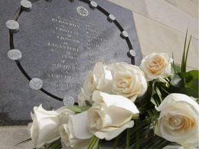 Fourteen white roses sit at the base of a memorial plaque at Ecole Polytechnique in  Montreal Friday December 6, 2013, to remember 14 victims of the massacre.  (Phil Carpenter / THE GAZETTE) ORG XMIT: 48715
Phil Carpenter, The Gazette