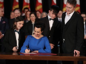 Newly sworn in Montreal Mayor Valérie Plante signs the city's "livre d'or" at Marché Bonsecours in Montreal on Thursday, Nov. 17, 2017.