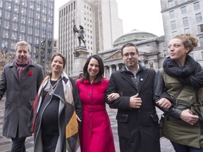 Montreal's new mayor Valerie Plante, centre, and elected city councillors, from left: François Limoges, Sophie Mauzerolle, Robert Beaudry and Rosannie Filato walk past a state of Paul de Chomedey de Maisonneuve, the founder of Montreal, Monday, November 6, 2017 in Montreal.