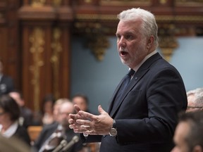 Quebec Premier Philippe Couillard responds during question period Tuesday, November 21, 2017 at the legislature in Quebec City. Couillard has criticized the manager of an Adidas store who reportedly told a Montreal crowd he would say a few words in French at an event to accommodate the city's francophone media.