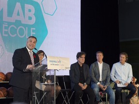 Quebec Education Minister Sébastien Proulx presents the Lab-École project at a press conference at a Quebec City school on Nov. 7, along with project founders (from left) Pierre Thibault, Ricardo Larivée and Pierre Lavoie.