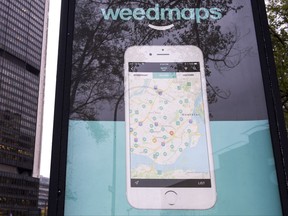 A sign advertising a Weedmaps mobile phone app Thursday, November 2, 2017 in Montreal. Ben Anson says he was outraged to see a large-scale billboard advertising Weedmaps, an app that lists local marijuana providers, crop up in a spot near several schools in Montreal earlier this year. But the 47-year-old says he also filed a police complaint against the marketing firm handling Weedmaps' advertising, believing the other ads that still remain around the city encourage people to engage in illegal activity. THE CANADIAN PRESS/Paul Chiasson