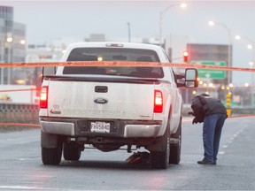 Montreal police examine a pickup truck that fatally struck a pedestrian on Décarie Blvd. in January 2017.