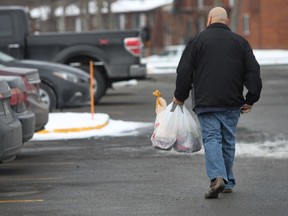 Shopper carry plastic grocery bags full of groceries