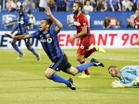 Montreal Impact's Matteo Mancosu is tripped by Chicago Fire goalkeeper Matt Lampson, right, during first half of MLS action in Montreal on Wednesday August 16, 2017.  Mancosu scored on the subsequent penalty kick.