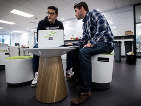 MONTREAL, QC.: OCTOBER 8, 2015 -- CEO, CTO and Heddoko founder Mazen Elbawab (left) and Chief Operating Officer Alexandre Fainberg (right) discuss about the technical roadmap, on Thursday October 8, 2015, in Montreal, Quebec. Heddoko is a startup that makes a compression suit with sensors to track athletes movement in real time.