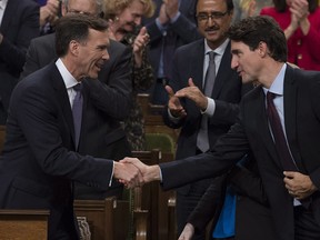 Finance Minister Bill Morneau shakes hands with Prime Minister Justin Trudeau after delivering his fall economic statement in the House of Commons in Ottawa, Tuesday, Oct.24, 2017.