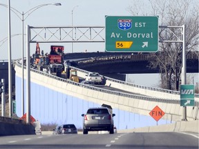 Workers put the finishing touches on the new ramp connecting Highway 20 West to Trudeau Airport, allowing drivers to avoid the Dorval Circle in Dorval, last Thursday.
