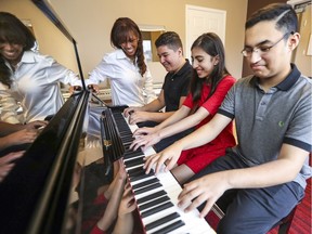 Music academy owner Tracey Steele with gold medalists Alex Lopez, Jennifer Benohanian and Ryan Edrissi (right).