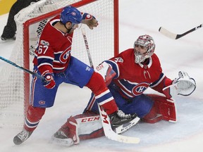 Canadiens' Max Pacioretty and goalie Carey Price get tangled up during play that saw Flames' Sean Monahan score the winning overtime goal at the Bell Centre Thursday night.