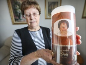 Françoise Goyette holds a photo of her sisiter in her apartment in the Ahuntsic district of Montreal on Wednesday, Dec. 6, 2017. In 2015, she and her 91-year-old sister, Madeleine, were evicted from their side-by-side apartments when their landlord repossessed the building to move family members in.  Madeleine died two months ago.