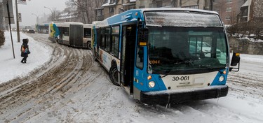 Montreal buses had a difficult time negotiating the southbound turn onto Atwater Ave. from Pine Ave. because of heavy snowfall Dec. 12, 2017.