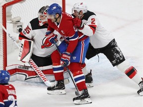 Montreal Canadiens' Max Pacioretty gets in close with New Jersey Devils goalie Cory Schneider and John Moore (2), during first period NHL action in Montreal on Thursday December 14, 2017.