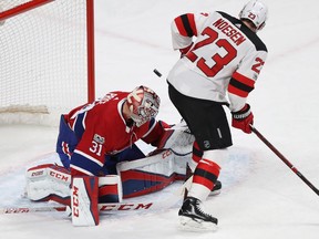 Montreal Canadiens goalie Carey Price stops puck on New Jersey Devils' Stefan Noesen (23), during second period NHL action in Montreal on Thursday Dec. 14, 2017.