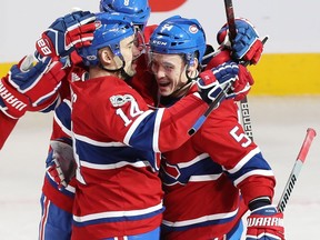 Canadiens' Tomas Plekanec (14) celebrates his winning goal with teammates  Charles Hudon (54) and Jordie Benn (8), during overtime Thursday night at the Bell Centre.