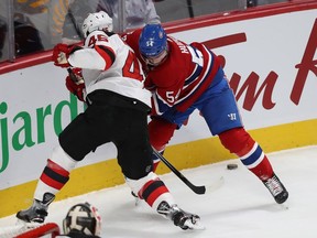 Canadiens' Charles Hudon, right, and Devils' Sami Vatanen battle for the puck during first period Thursday night at the Bell Centre.