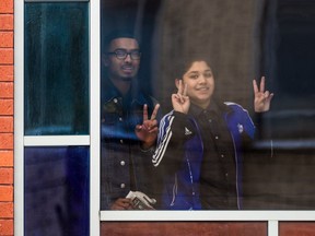 Kids flash the peace symbol from the Baitul-Mukarram Mosque in Montreal on Friday December 15, 2017.
