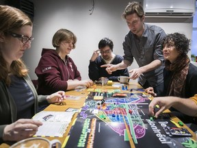 New board game inventor Dave Loach tells players how to play the game called Construction & Corruption in Montreal  on Saturday Dec. 16, 2017.