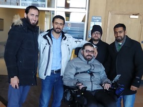 A crowdfunding campaign is raising funds for adapting the house of Aymen Derbali, centre, to be wheelchair-accessible. He is paralyzed after being shot seven times at a mosque in Quebec City on Jan. 29, 2017.