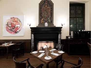 A fireside dining table in the university room at the University Club of Montreal on Tuesday December 19, 2017.  The painting, by Canadian artist Harold Klunder, was acquired in the spring of 1917 for the club's 110th anniversary.