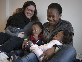 Sara Dubuc (left) with Nigerian refugee Loveth Itohan and her three children — a six-month-old baby and two-year-old twin boys. Itohan came to Canada with nothing, and N.D.G. residents have rallied to help her out.