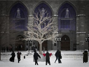 Tourists gather outside Notre-Dame church in Old Montreal on Monday, Dec. 25, 2017.