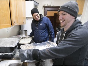Zack Ingles, right, and David Chapman prepare the Christmas meal at Open Door on Monday, Dec. 25, 2017.