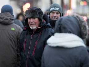Felix Hausermann sports a red face and warm hat as he braves the cold to walk on Ste-Catherine St. with his family as Montreal enters a cold snap on Wednesday.