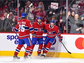 The Canadiens’ Paul Byron (right) celebrates with teammates Jacob de la Rose and Victor Mete after scoring one of his three goals against the Detroit Red Wings during NHL game at the Bell Centre in Montreal on Dec. 2, 2017.