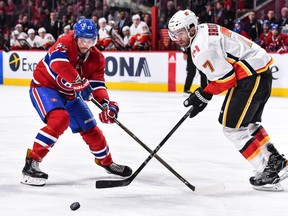 Canadiens' Alex Galchenyuk, left, and Flames' T.J. Brodie chase the puck Thursday night at the Bell Centre.