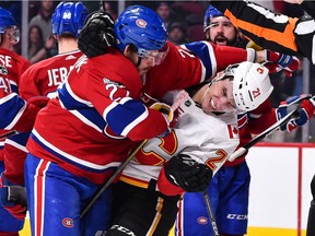 The Canadiens’ Alex Galchenyuk battles with the Calgary Flames' Garnet Hathaway during game at the Bell Centre in Montreal on Dec. 7, 2017.