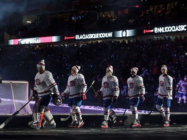 Members of the Montreal Canadiens walk down to the ice prior to the 2017 NHL 100 Classic against the Ottawa Senators at Lansdowne Park on Saturday, Dec. 16, 2017, in Ottawa.