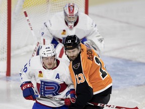 Laval Rocket defenceman Matt Taormina is tied up by Lehigh Valley Phantoms Colin McDonald during AHL action in Montreal on Friday November 17, 2017.