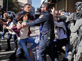 Israeli police disperse Palestinian protesters on December 9, 2017, in East Jerusalem. Retaliatory Israeli air strikes on the Gaza Strip killed two Hamas militants, as unrest simmered across the Palestinian territories over U.S. President Donald Trump's declaration of Jerusalem as Israel's capital.