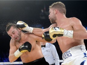 Billy Joe Saunders, right, lands a hit on David Lemieux during WBO middleweight title fight action in Laval on Saturday, Dec. 16, 2017.