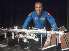 Quebec astronaut David Saint-Jacques with a model of the International Space Station. He'll be heading there in 2018.