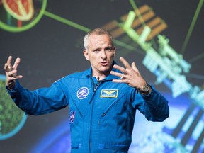Quebec astronaut David Saint-Jacques with a model of the International Space Station. He'll be heading there in 2018.