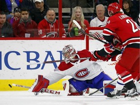 Canadiens goalie Carey Price clears a shot by Hurricanes' Elias Lindholm during first period Wednesday night in Raleigh, N.C.